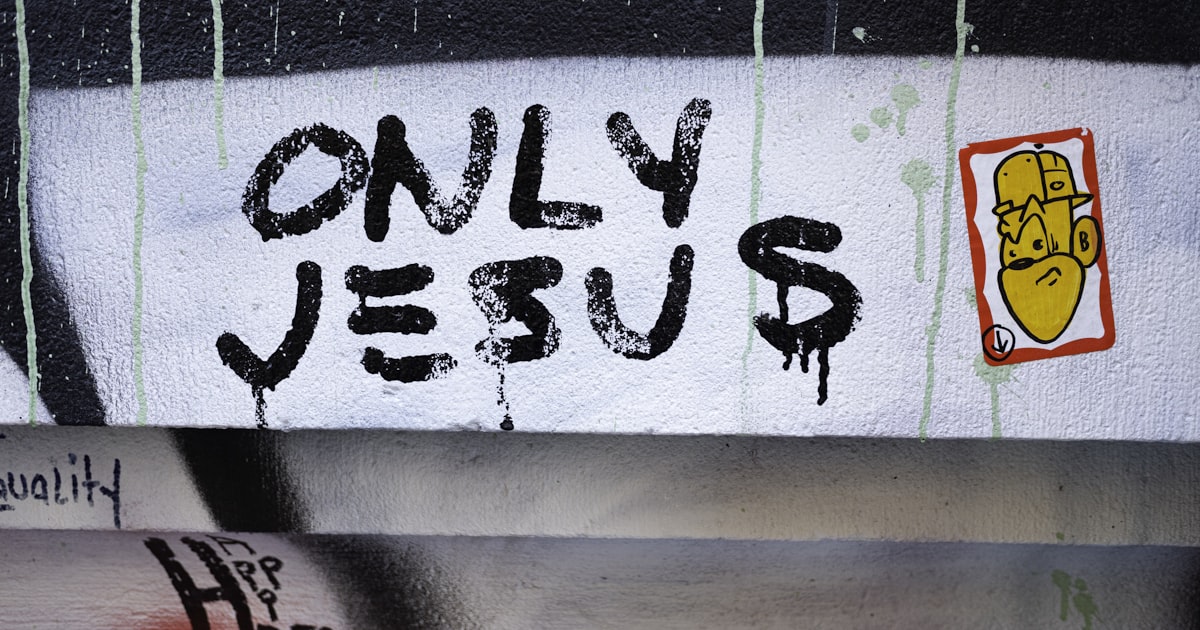 Graffiti with text "only jesus" and homer simpson sticker