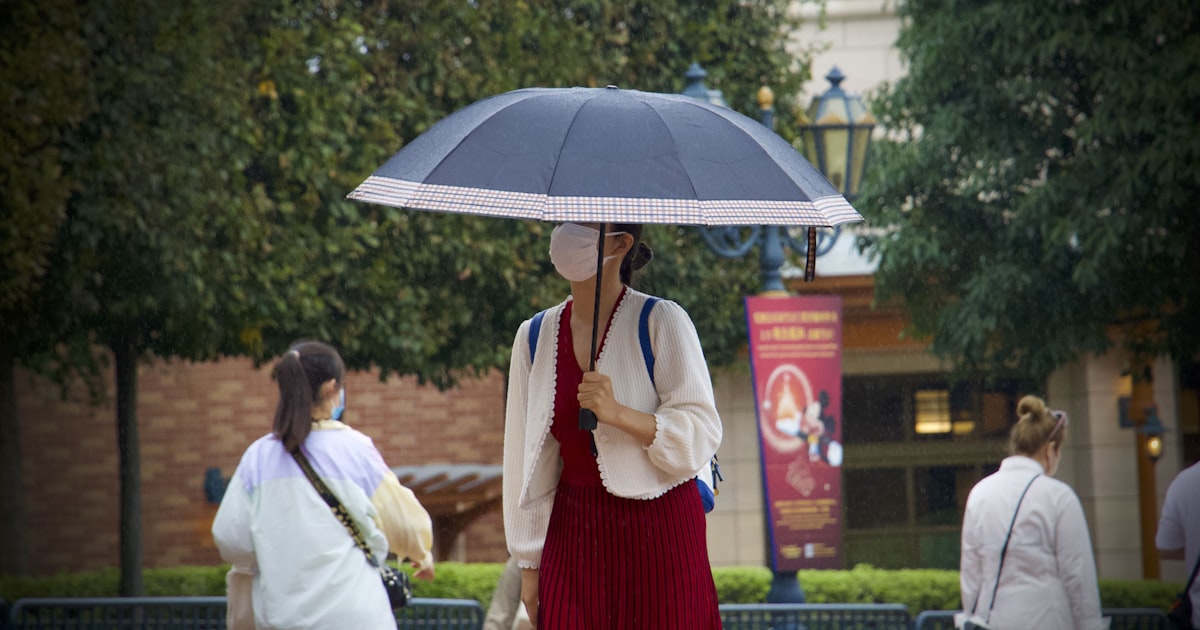 a person in a red dress holding an umbrella